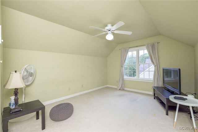 interior space with carpet flooring, vaulted ceiling, baseboards, and ceiling fan