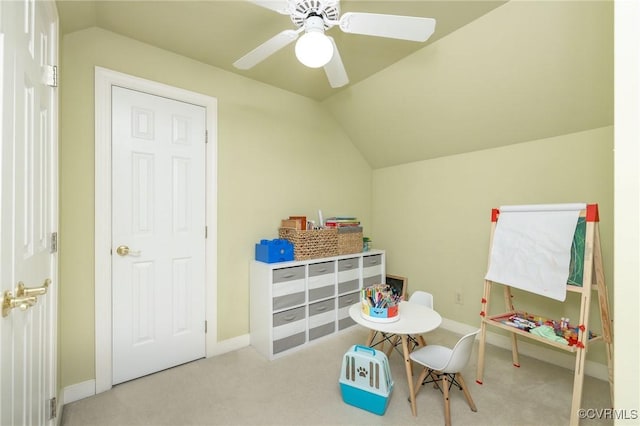 recreation room featuring lofted ceiling, carpet floors, a ceiling fan, and baseboards