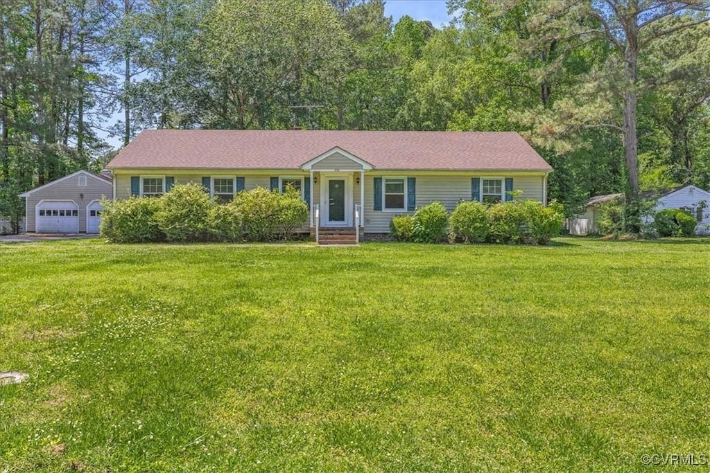 single story home featuring a garage and a front yard