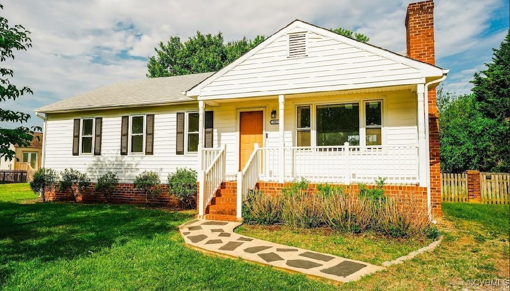 view of front of house with a chimney and a porch