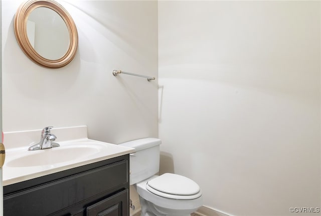 half bathroom featuring toilet and vanity
