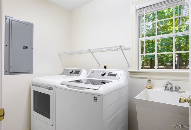laundry area featuring electric panel and independent washer and dryer