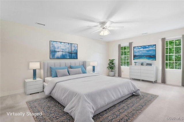 bedroom with baseboards, ceiling fan, and carpet