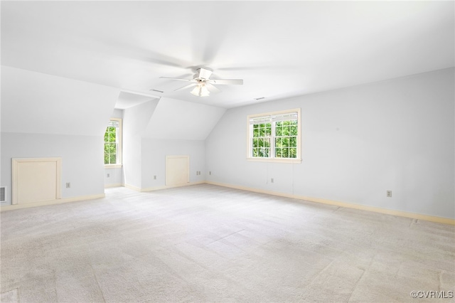 additional living space featuring ceiling fan, plenty of natural light, baseboards, lofted ceiling, and carpet flooring