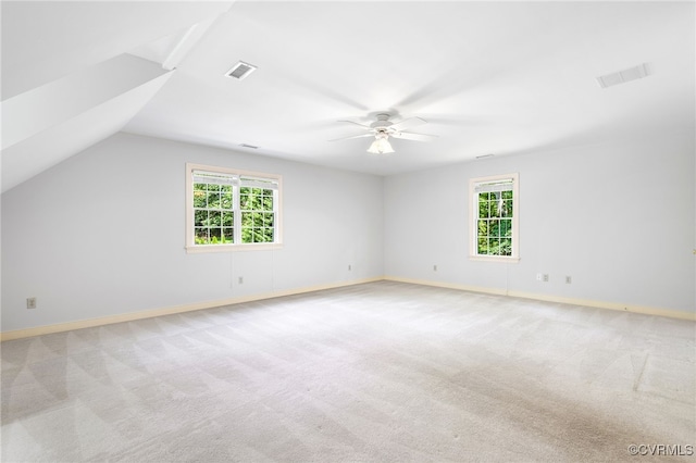 spare room featuring a ceiling fan, carpet, baseboards, and lofted ceiling