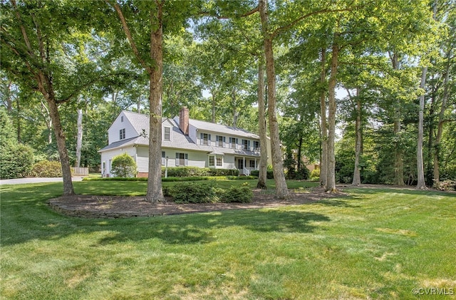 view of front of house featuring a front yard and a chimney