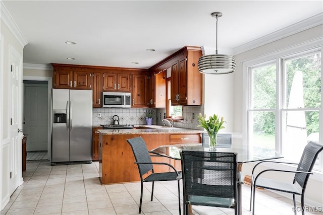 kitchen featuring light stone countertops, pendant lighting, crown molding, decorative backsplash, and stainless steel appliances