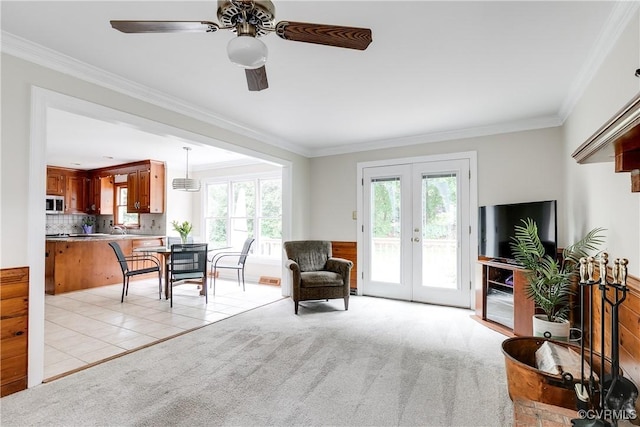 interior space with a ceiling fan, ornamental molding, and french doors