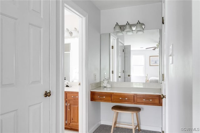 bathroom featuring a ceiling fan and vanity
