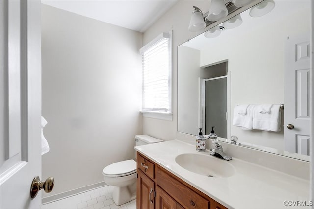 bathroom featuring a stall shower, tile patterned floors, vanity, and toilet