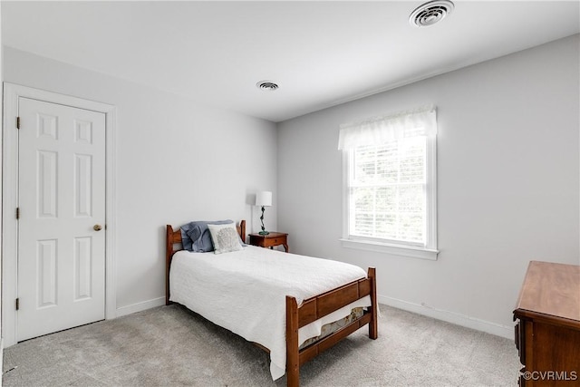 bedroom featuring light carpet, baseboards, and visible vents