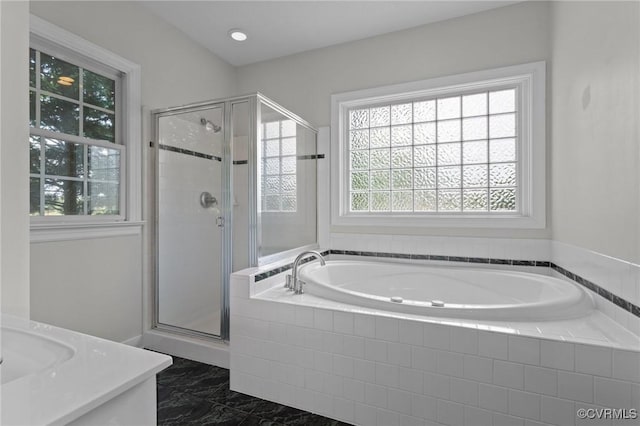 full bath featuring marble finish floor, a bath, a shower stall, and a healthy amount of sunlight