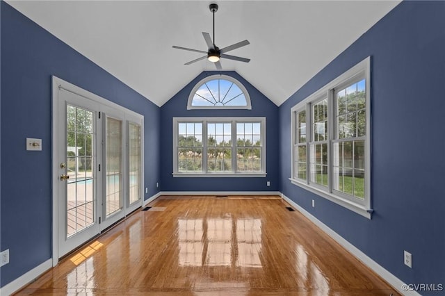 unfurnished room with vaulted ceiling, ceiling fan, baseboards, and wood finished floors