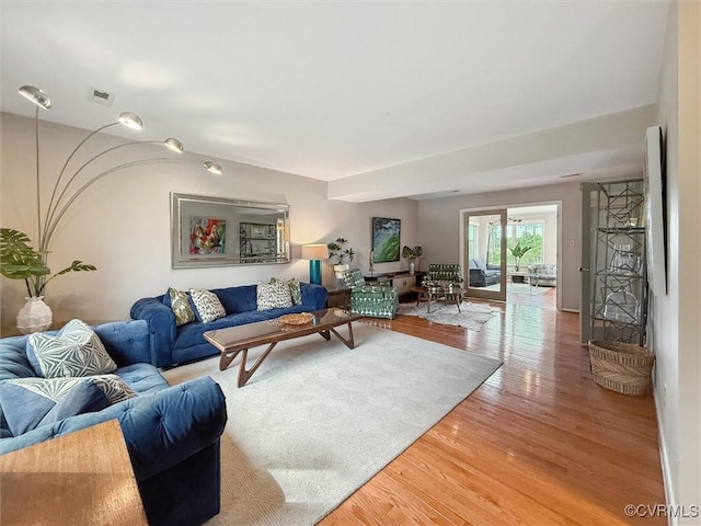 living room featuring light wood finished floors and visible vents