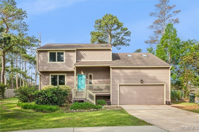 view of front of home featuring concrete driveway, fence, and a front yard