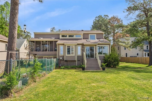 rear view of property with a sunroom, crawl space, fence private yard, and a lawn