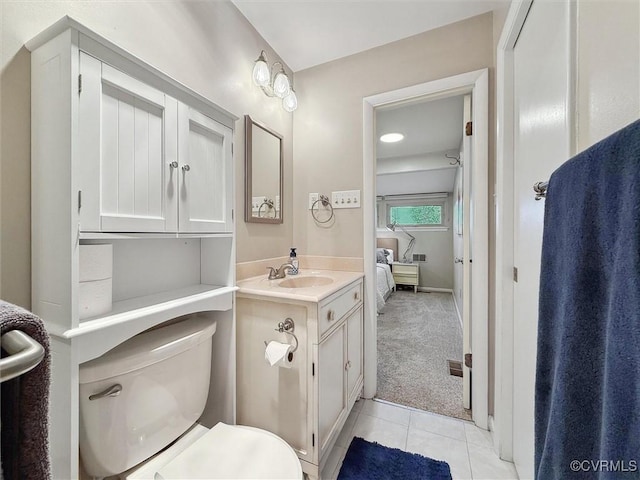 bathroom featuring tile patterned floors, toilet, ensuite bathroom, and vanity