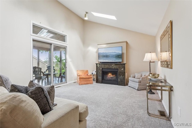 living area with a fireplace, carpet floors, baseboards, and high vaulted ceiling