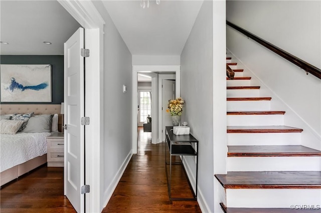 stairway with wood finished floors, baseboards, and recessed lighting