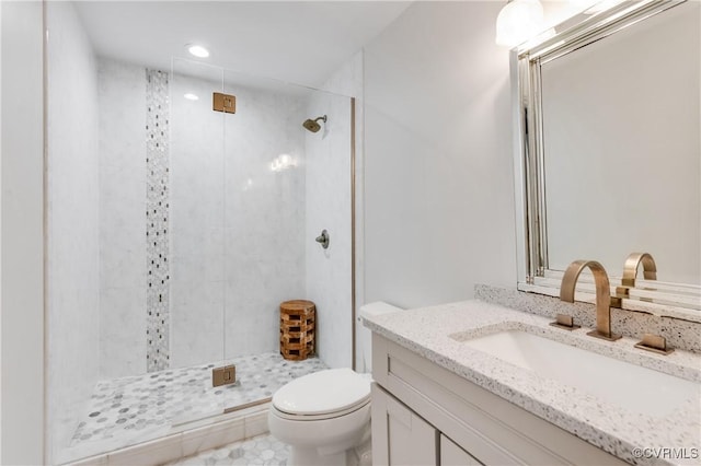 full bath with a stall shower, recessed lighting, vanity, and toilet