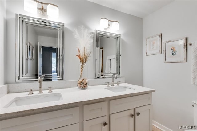 full bathroom featuring a sink and double vanity