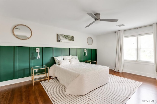 bedroom featuring visible vents, wood finished floors, and a ceiling fan