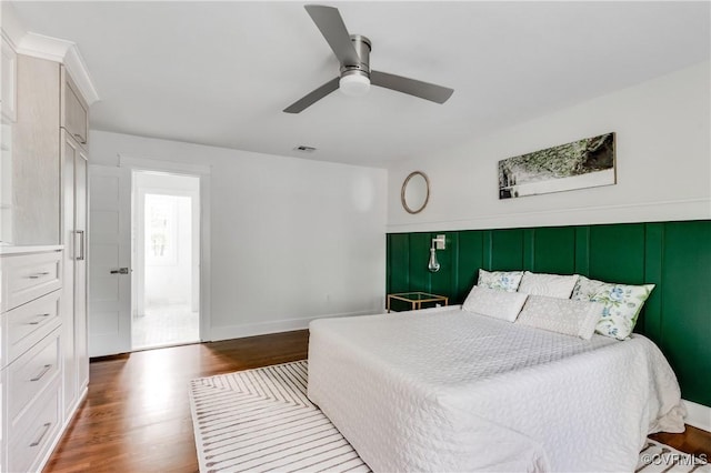 bedroom with visible vents, ceiling fan, and wood finished floors