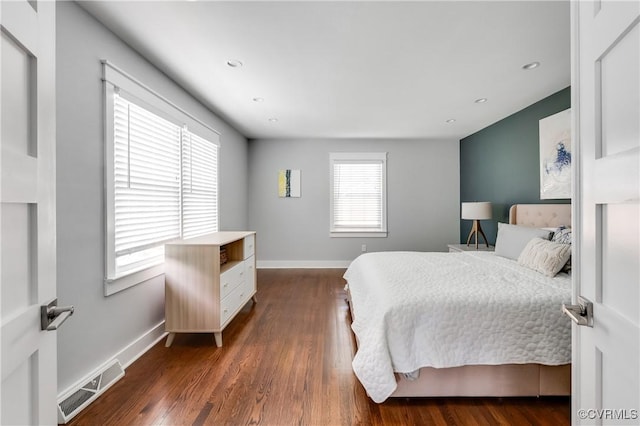 bedroom with recessed lighting, baseboards, visible vents, and dark wood finished floors