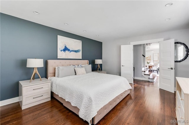 bedroom featuring baseboards, dark wood finished floors, and recessed lighting