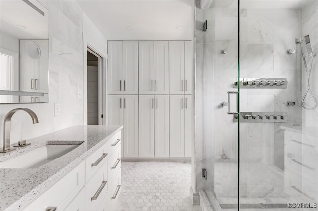 full bath with vanity, decorative backsplash, and a shower stall