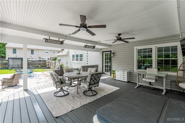deck featuring a ceiling fan, outdoor dining space, and fence