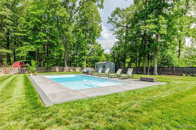 view of pool with an outdoor structure, a storage unit, a patio, a fenced backyard, and a lawn