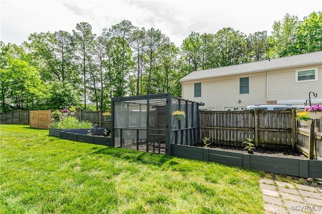 view of yard with a vegetable garden and a fenced backyard