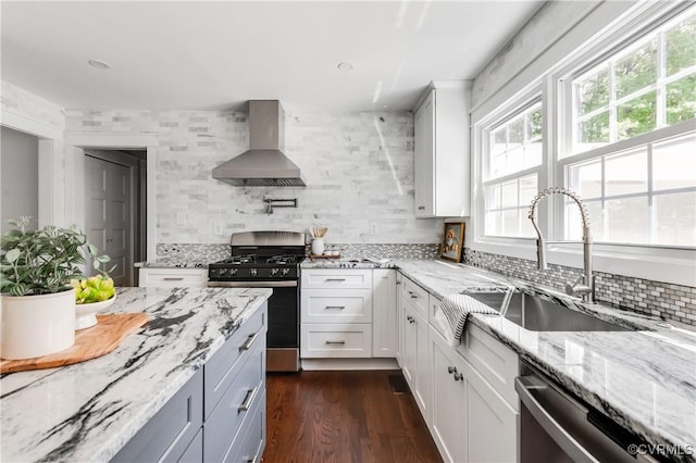 10102 Cherrywood Dr, Richmond, VA 23238 - kitchen featuring wall chimney range hood, stainless steel appliances, tasteful backsplash, and light stone countertops