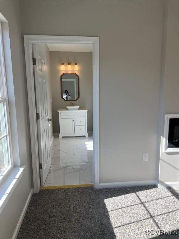 731 Wilson St, Petersburg, VA 23803 - corridor with a sink, marble look tiles, and baseboards