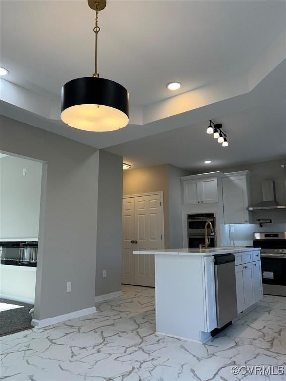 731 Wilson St, Petersburg, VA 23803 - kitchen with stainless steel appliances, wall chimney exhaust hood, recessed lighting, light marble finish floors, and light countertops