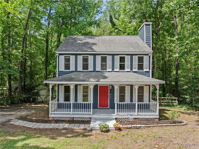 view of front of property with a chimney, a porch, and a shingled roof