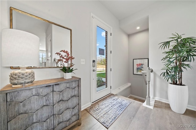foyer with plenty of natural light, wood finished floors, baseboards, and recessed lighting
