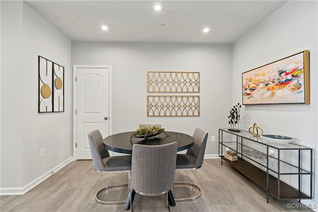 dining space with baseboards, recessed lighting, and wood finished floors