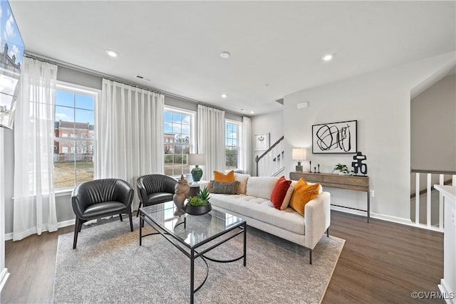 living room featuring baseboards, dark wood-style flooring, stairway, and recessed lighting