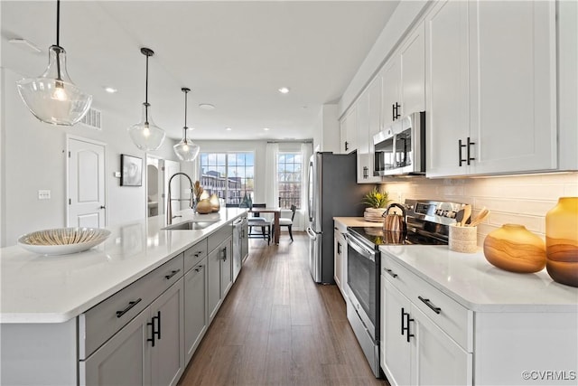 kitchen featuring a sink, recessed lighting, a center island with sink, and appliances with stainless steel finishes