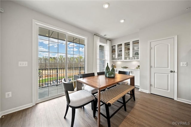dining room with visible vents, wood finished floors, baseboards, and recessed lighting