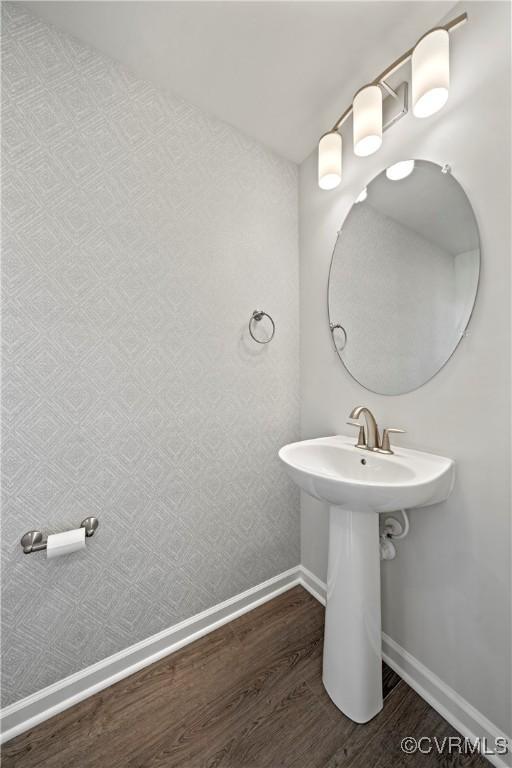 bathroom with wood finished floors and baseboards