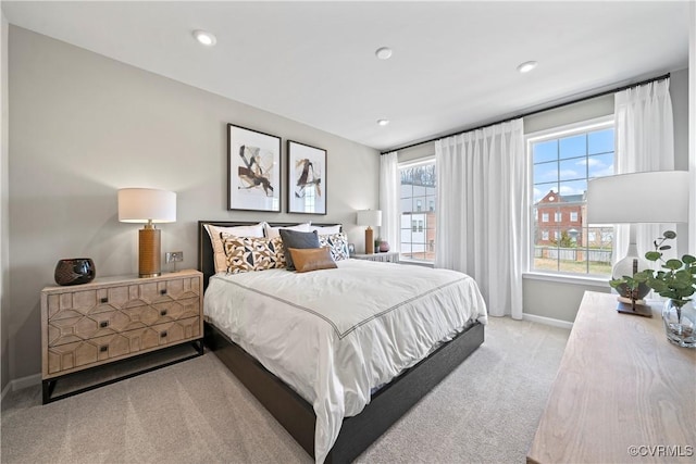 carpeted bedroom featuring baseboards and recessed lighting
