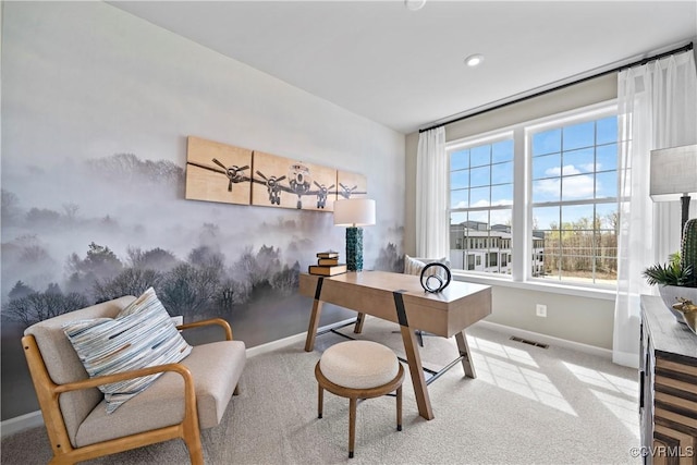 carpeted office space with baseboards, a wealth of natural light, and visible vents