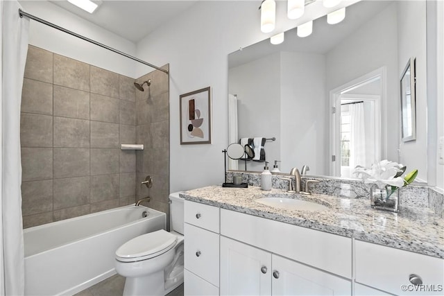 bathroom with toilet, vanity, and shower / tub combination