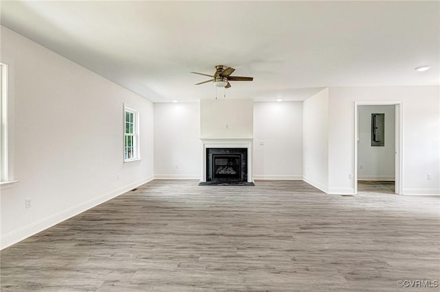 1684 Halls Store Rd, Mineral, VA 23117 - unfurnished living room featuring a fireplace, baseboards, a ceiling fan, and wood finished floors