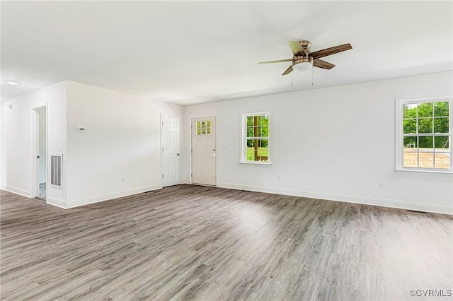 1684 Halls Store Rd, Mineral, VA 23117 - unfurnished living room with a healthy amount of sunlight, baseboards, visible vents, and wood finished floors