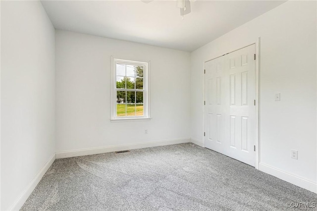 1684 Halls Store Rd, Mineral, VA 23117 - unfurnished bedroom with a closet, visible vents, ceiling fan, carpet flooring, and baseboards