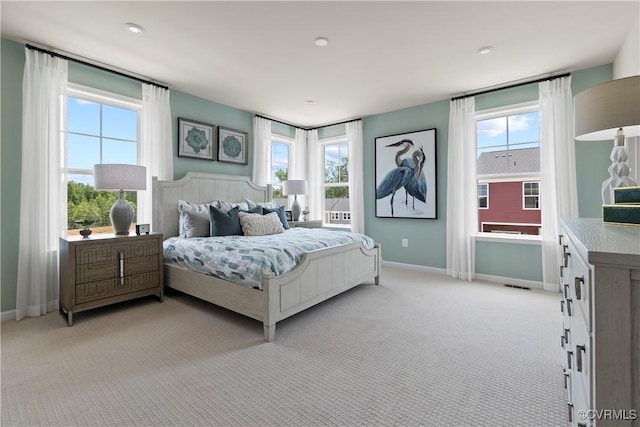 bedroom with multiple windows and baseboards